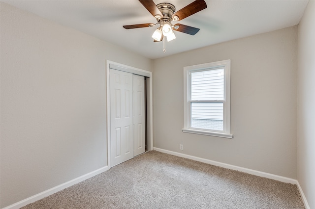 unfurnished bedroom with carpet floors, a closet, and ceiling fan