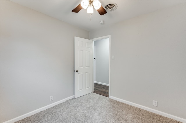 unfurnished room with ceiling fan and carpet floors