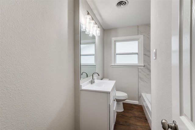 bathroom featuring wood-type flooring, vanity, and toilet