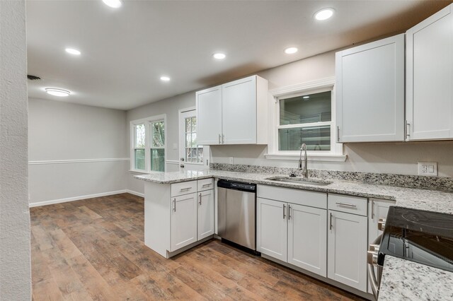 kitchen featuring white cabinets, appliances with stainless steel finishes, wood-type flooring, and sink