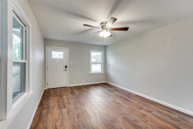 entryway featuring a textured ceiling, ceiling fan, and dark wood-type flooring