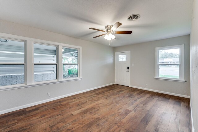 unfurnished room with dark hardwood / wood-style flooring and ceiling fan