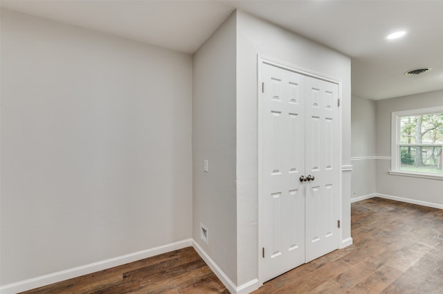 corridor with hardwood / wood-style floors