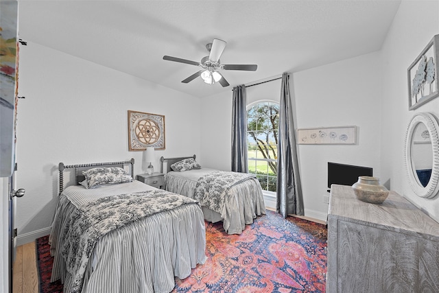 bedroom with ceiling fan and hardwood / wood-style flooring