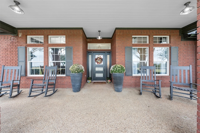 view of exterior entry featuring a porch