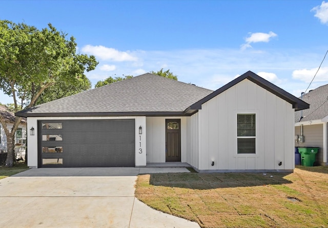 view of front of house with a garage and a front lawn