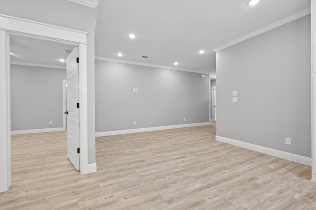 unfurnished room featuring ornamental molding and light hardwood / wood-style flooring