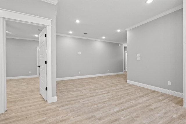 empty room featuring ornamental molding and light hardwood / wood-style floors