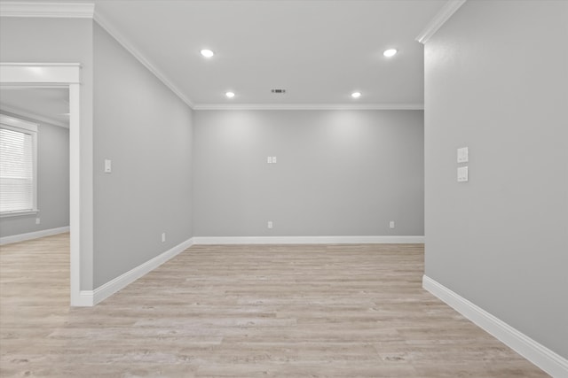 empty room with light hardwood / wood-style flooring and crown molding