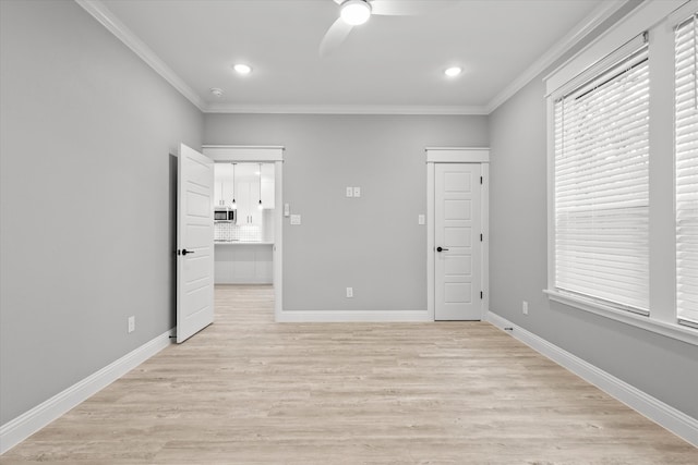 unfurnished bedroom featuring ceiling fan, ornamental molding, and light hardwood / wood-style flooring