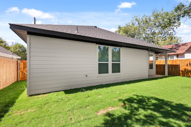 rear view of house with a yard