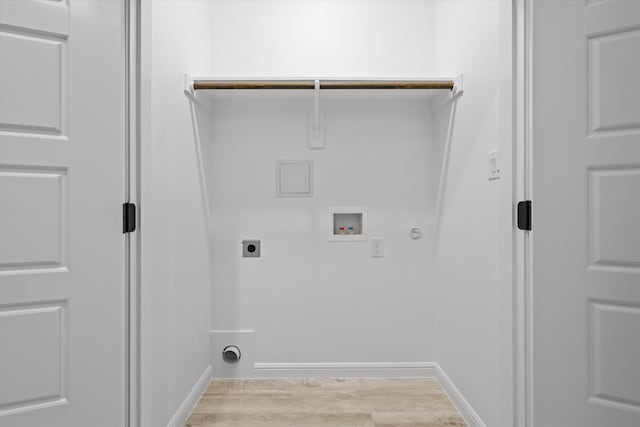 laundry area with washer hookup, hookup for a gas dryer, hookup for an electric dryer, and light hardwood / wood-style flooring