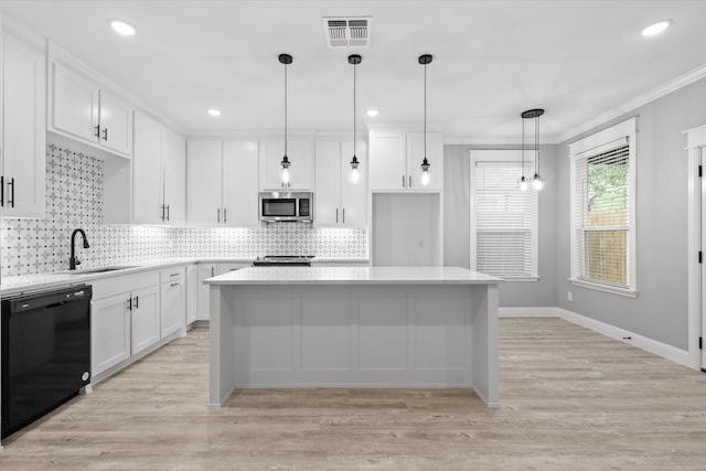 kitchen with sink, white cabinetry, ornamental molding, and appliances with stainless steel finishes