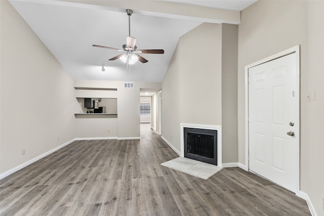 unfurnished living room featuring hardwood / wood-style flooring, ceiling fan, and lofted ceiling