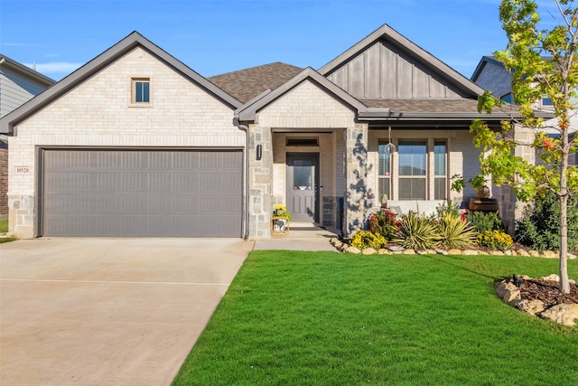 view of front of home with a garage and a front lawn