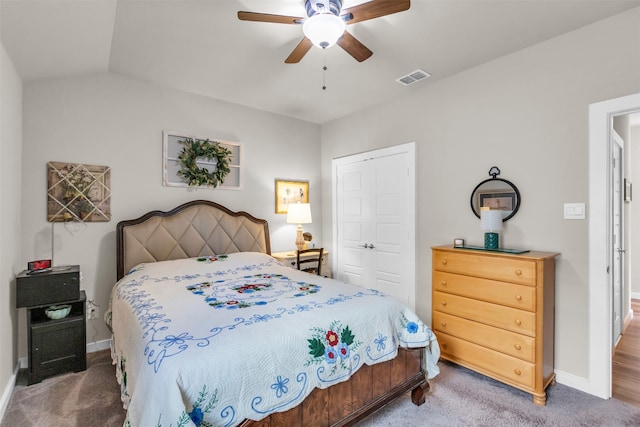 bedroom with ceiling fan, vaulted ceiling, carpet floors, and a closet