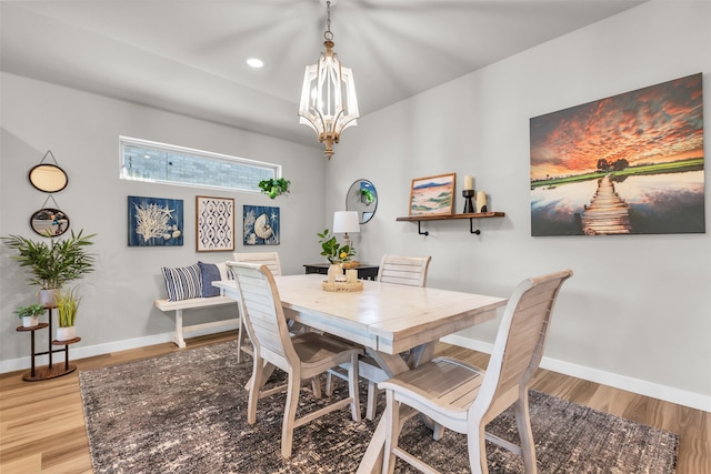 dining area featuring a chandelier and light hardwood / wood-style floors