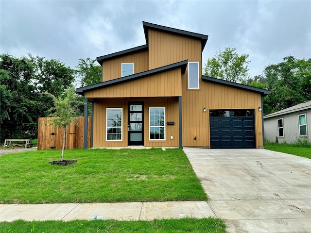 contemporary home featuring a garage and a front yard