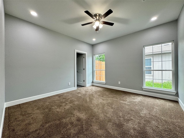 unfurnished room featuring carpet, a wealth of natural light, and ceiling fan