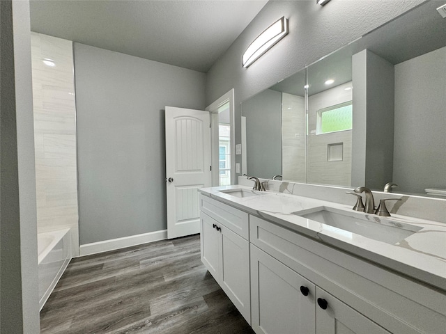 bathroom with vanity, wood-type flooring, and bathtub / shower combination