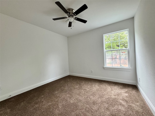 empty room with ceiling fan and carpet floors