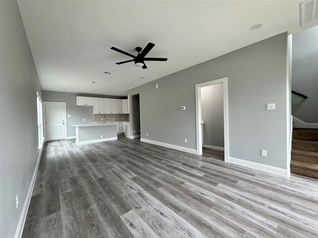 unfurnished living room featuring ceiling fan and light hardwood / wood-style flooring