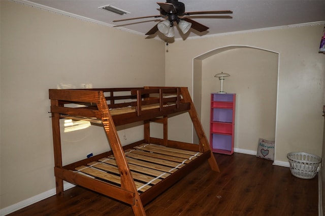 bedroom featuring crown molding and dark wood-type flooring