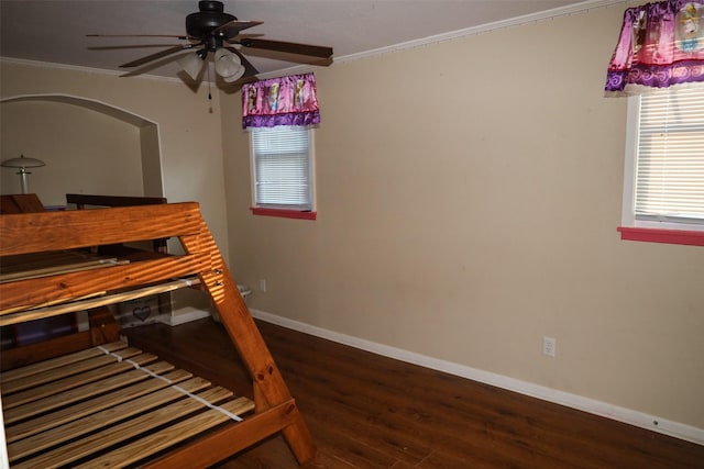 bedroom featuring ceiling fan, dark hardwood / wood-style flooring, and ornamental molding