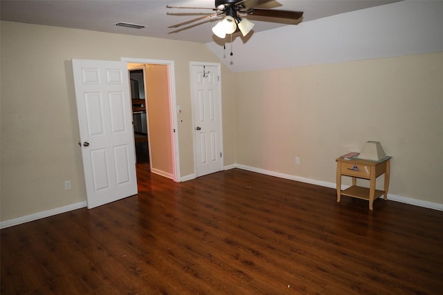 empty room with dark hardwood / wood-style flooring, ceiling fan, and lofted ceiling