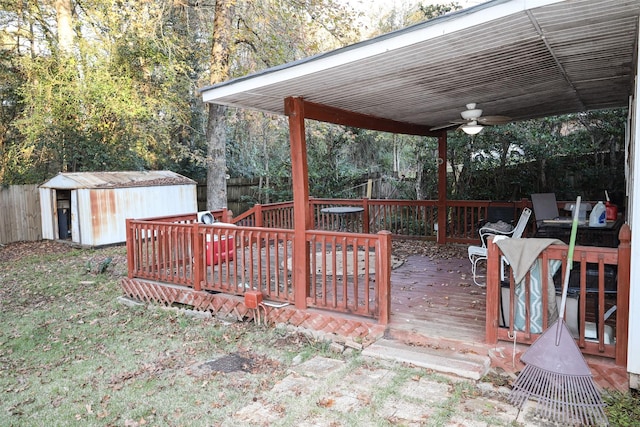 deck featuring ceiling fan and a shed