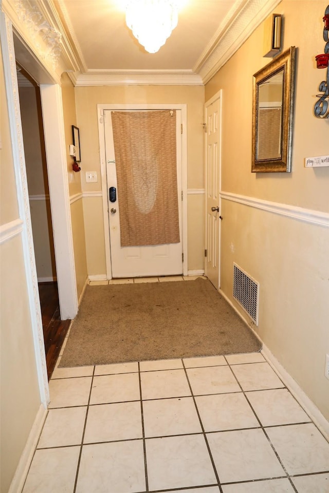 hallway featuring light tile patterned floors and crown molding