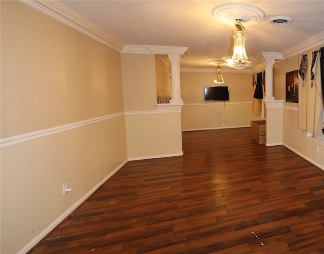 unfurnished room featuring dark wood-type flooring, ornamental molding, a chandelier, and decorative columns