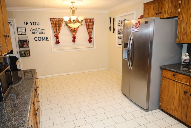 kitchen featuring stainless steel appliances, crown molding, decorative light fixtures, dark stone countertops, and a chandelier