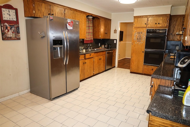 kitchen featuring sink, backsplash, ornamental molding, and appliances with stainless steel finishes