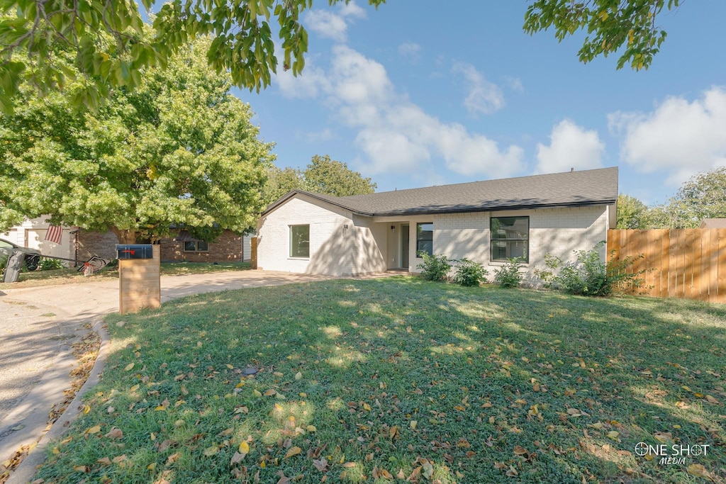 ranch-style house with a front lawn