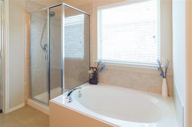 bathroom featuring plus walk in shower and tile patterned floors