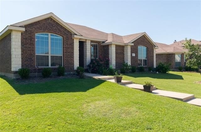 ranch-style home featuring a front yard