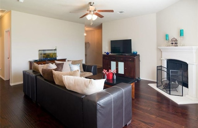 living room featuring ceiling fan and dark hardwood / wood-style flooring