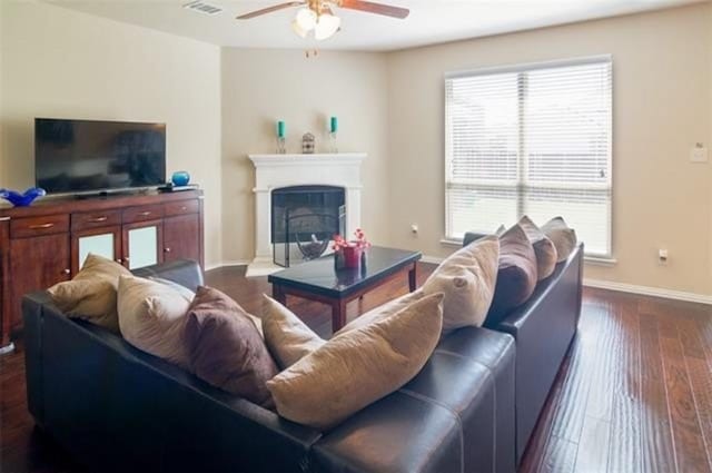 living room featuring dark hardwood / wood-style floors and ceiling fan