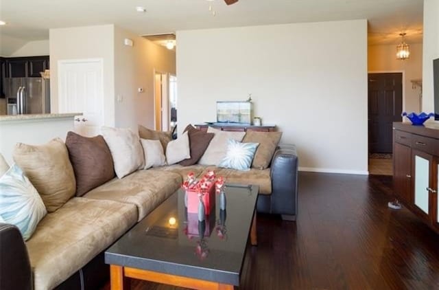 living room featuring dark hardwood / wood-style floors and ceiling fan