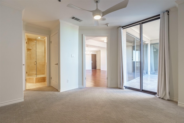 unfurnished room with light carpet, crown molding, a wealth of natural light, and ceiling fan