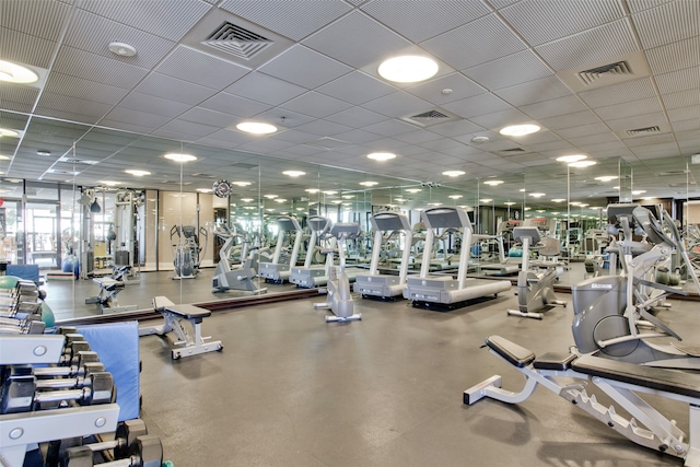 exercise room with a paneled ceiling