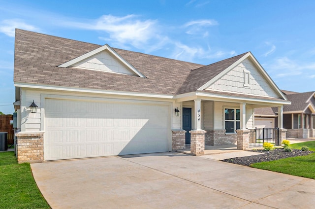 craftsman-style home with covered porch and central air condition unit