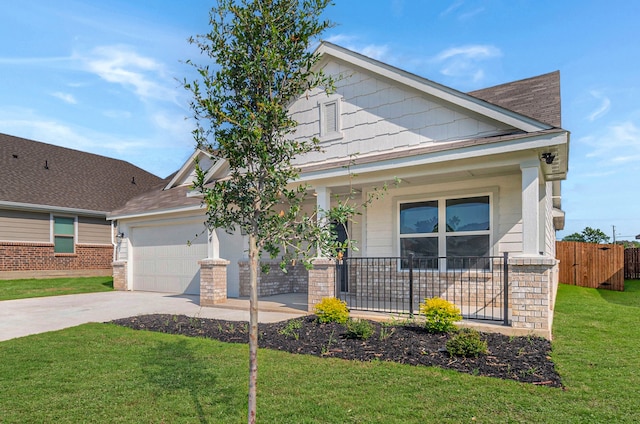 view of front facade featuring a front lawn, a porch, and a garage