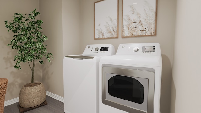 clothes washing area featuring washing machine and dryer and wood-type flooring