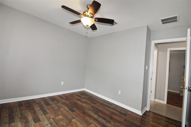 unfurnished room featuring ceiling fan and dark hardwood / wood-style flooring