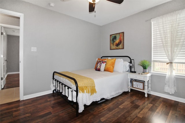 bedroom with ceiling fan and dark hardwood / wood-style floors