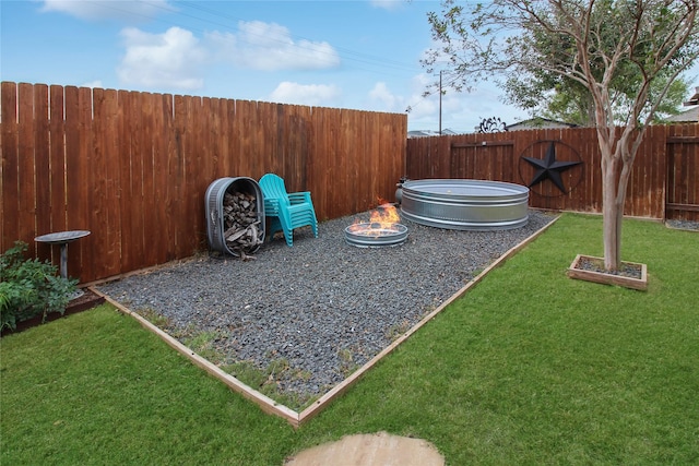 view of yard featuring an outdoor fire pit