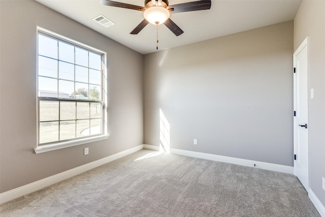 empty room with ceiling fan and light carpet