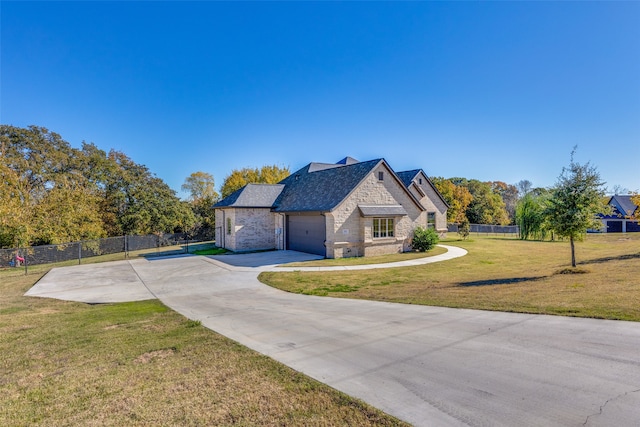 french provincial home with a garage and a front lawn